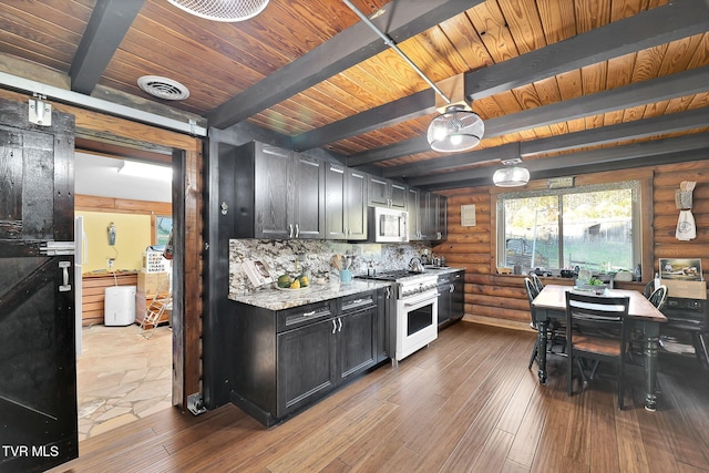 kitchen featuring log walls, beam ceiling, high end stove, and light stone countertops