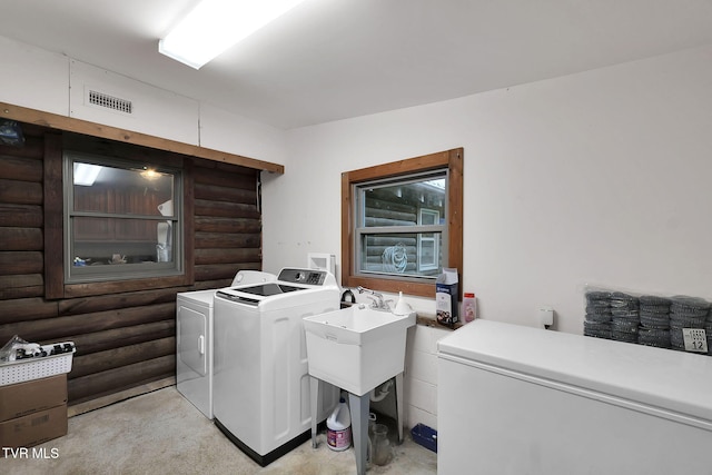 clothes washing area with washer and dryer