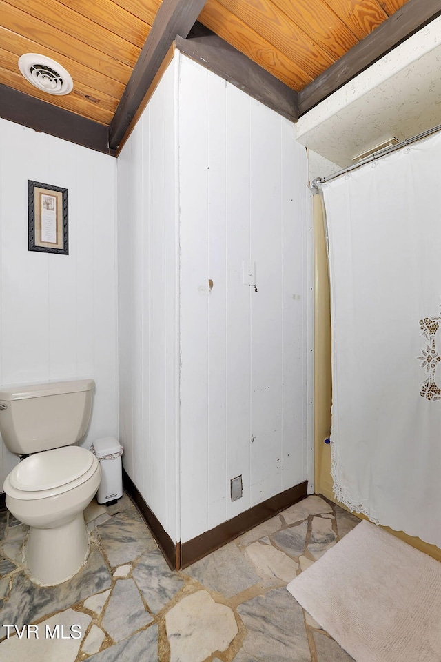 bathroom with wooden ceiling and toilet