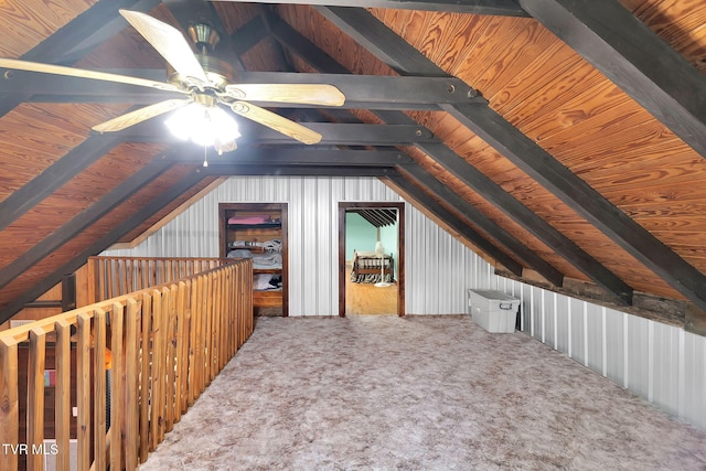 interior space featuring ceiling fan, carpet floors, and lofted ceiling with beams