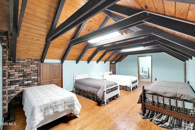 bedroom featuring hardwood / wood-style flooring, lofted ceiling with beams, and wood ceiling