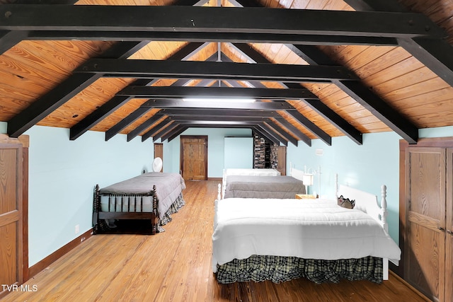 bedroom featuring hardwood / wood-style flooring, lofted ceiling with beams, and wood ceiling