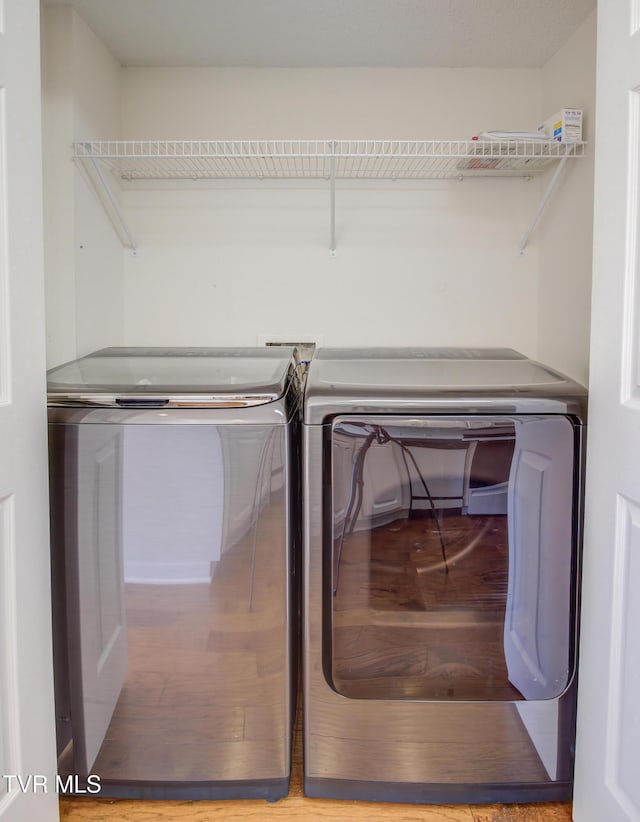 laundry area featuring hardwood / wood-style floors and washer and dryer