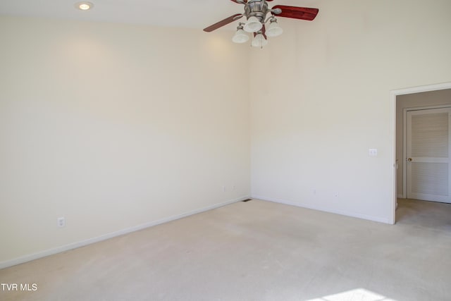 carpeted empty room featuring ceiling fan