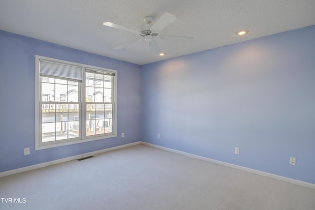 empty room with ceiling fan and carpet floors