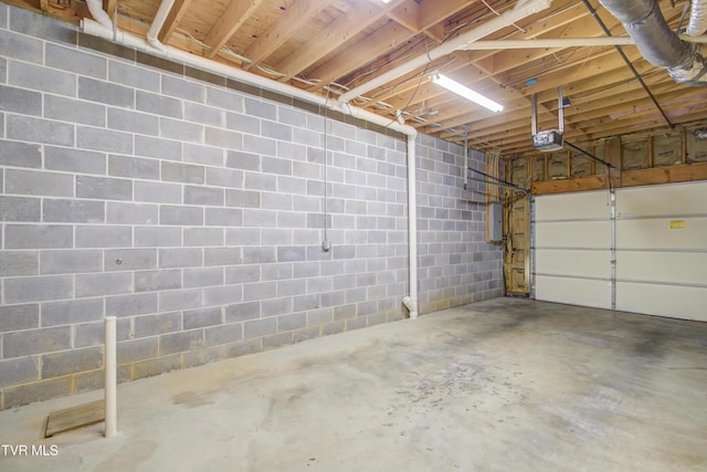 garage featuring electric panel and a garage door opener