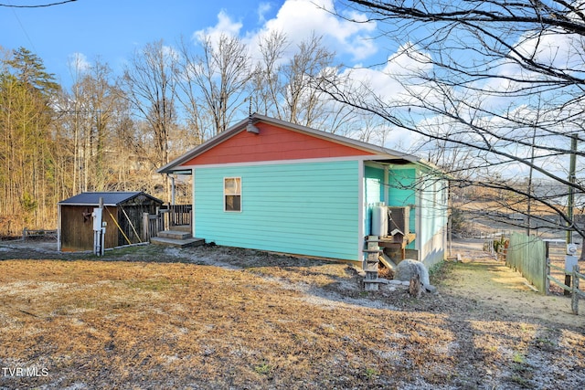 view of property exterior with a storage shed