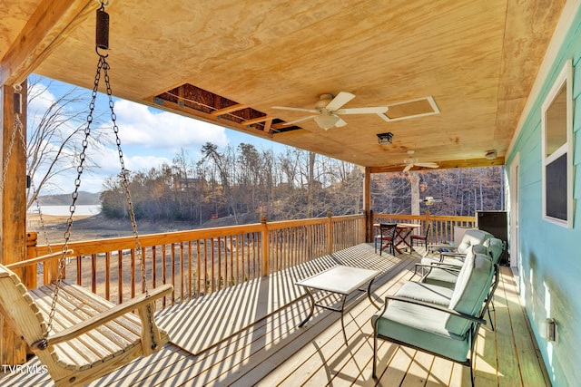 wooden deck featuring ceiling fan