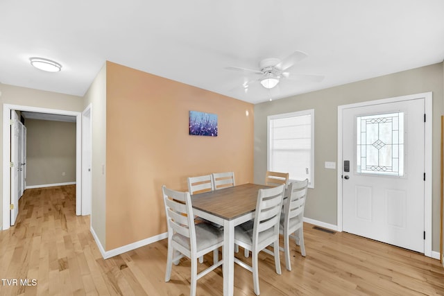 dining area featuring light wood-type flooring and ceiling fan