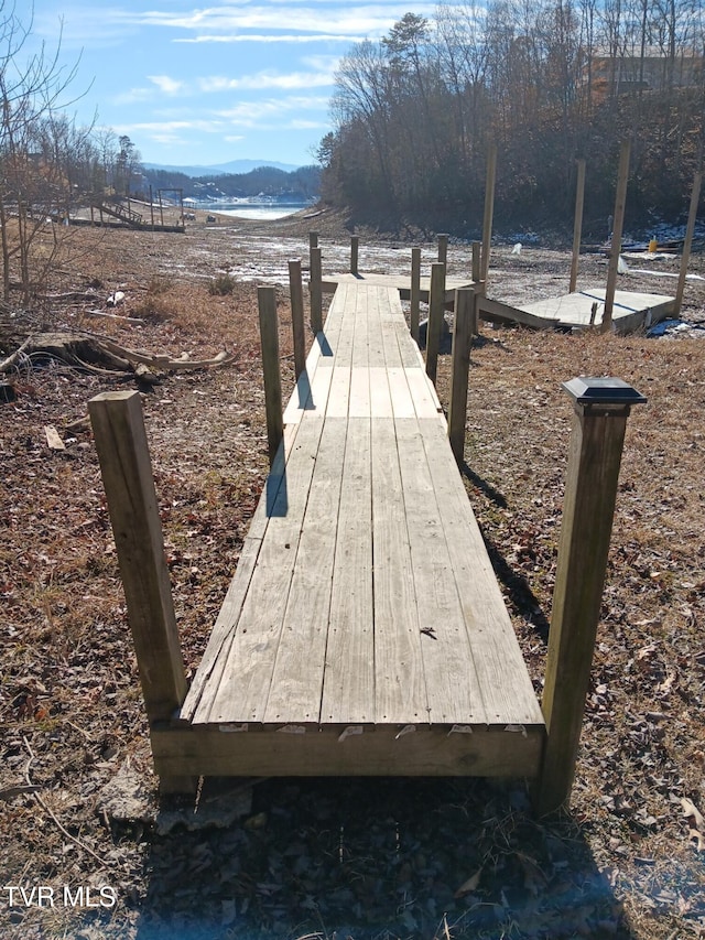 view of dock featuring a water and mountain view