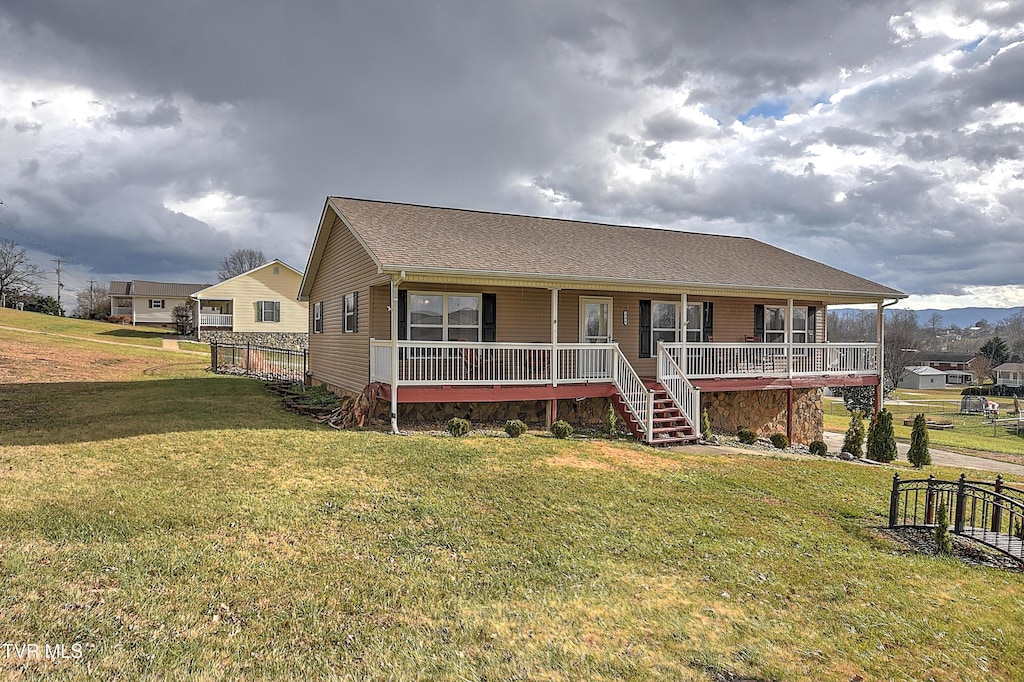 view of front of home with a porch and a front yard