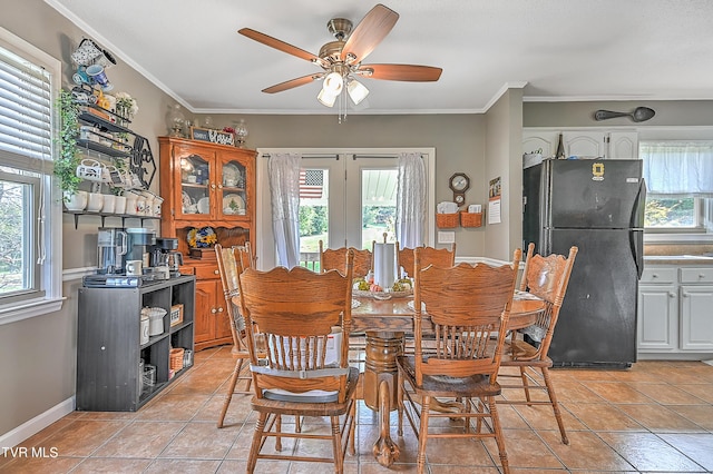 dining room featuring ceiling fan, plenty of natural light, ornamental molding, and light tile patterned flooring