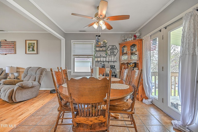 dining area featuring ornamental molding, ceiling fan, a healthy amount of sunlight, and light tile patterned flooring