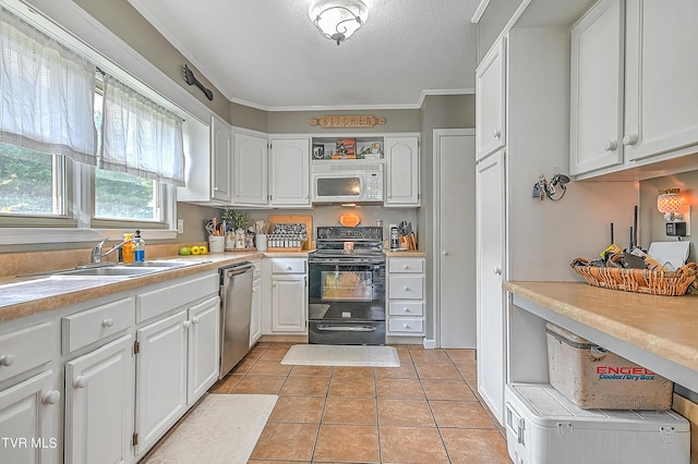 kitchen featuring electric range, dishwasher, light tile patterned floors, crown molding, and white cabinets