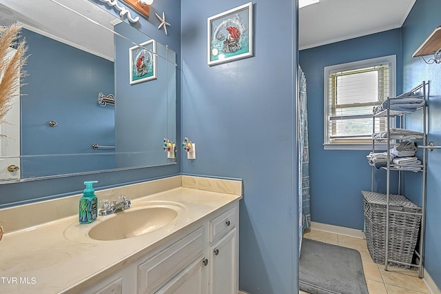 bathroom featuring tile patterned flooring, vanity, and crown molding