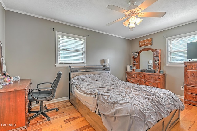 bedroom with ceiling fan, crown molding, and light hardwood / wood-style flooring