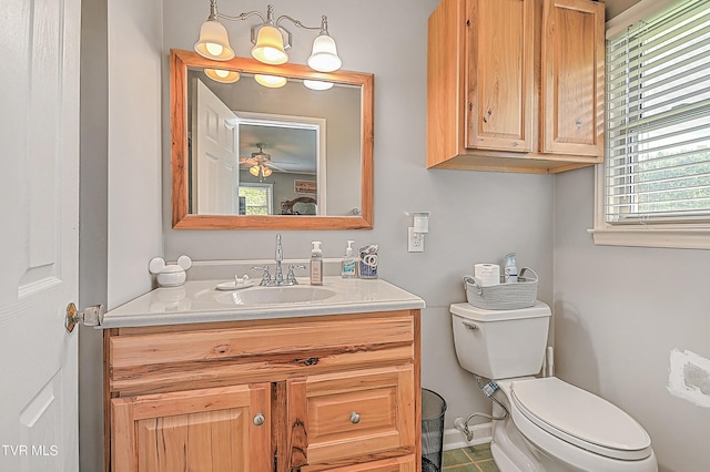 bathroom featuring vanity, toilet, and ceiling fan