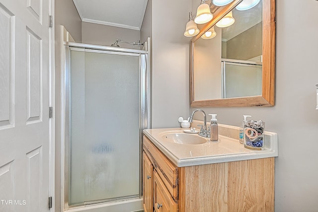 bathroom with crown molding, a shower with door, and vanity