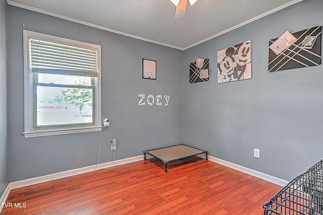 bedroom with ceiling fan, ornamental molding, and hardwood / wood-style flooring