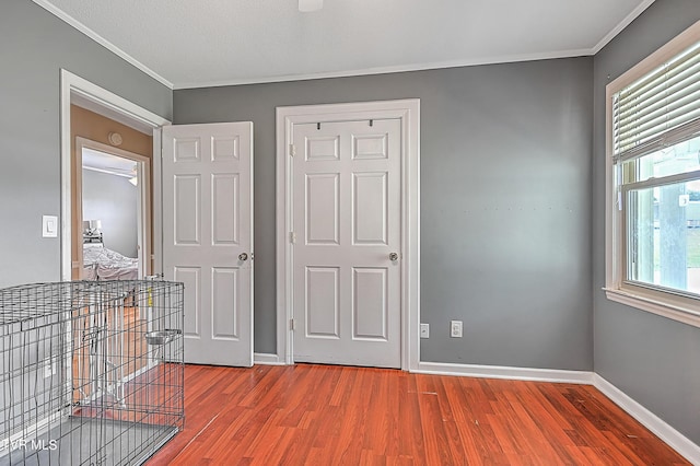 interior space featuring ornamental molding and hardwood / wood-style flooring