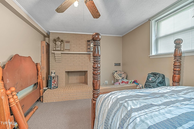 carpeted bedroom featuring a textured ceiling, ceiling fan, ornamental molding, and a fireplace