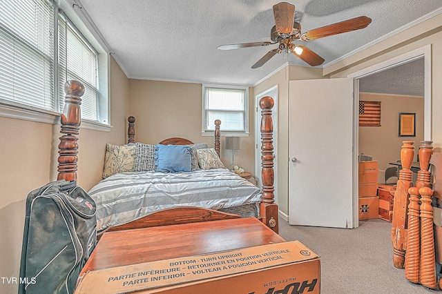 carpeted bedroom featuring ceiling fan, ornamental molding, and a textured ceiling