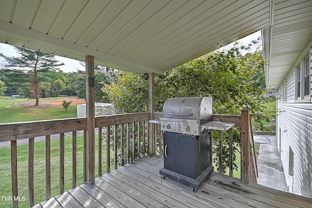 deck with a yard and area for grilling