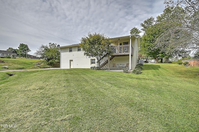 rear view of property featuring a lawn