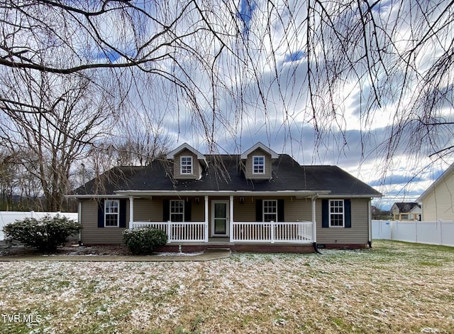 view of front of house with covered porch and a front yard