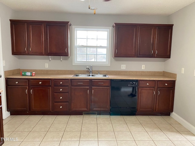 kitchen featuring a textured ceiling, light tile patterned flooring, sink, and black dishwasher