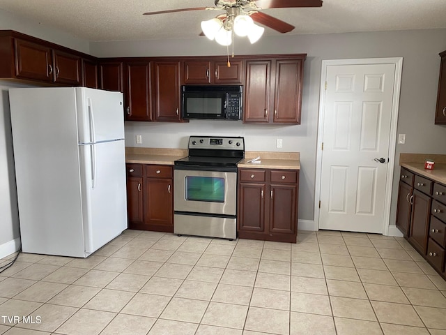 kitchen with stainless steel electric stove, white refrigerator, ceiling fan, light tile patterned floors, and a textured ceiling