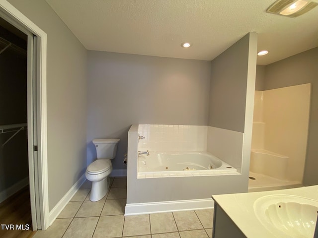 bathroom featuring vanity, tile patterned flooring, toilet, a textured ceiling, and a tub