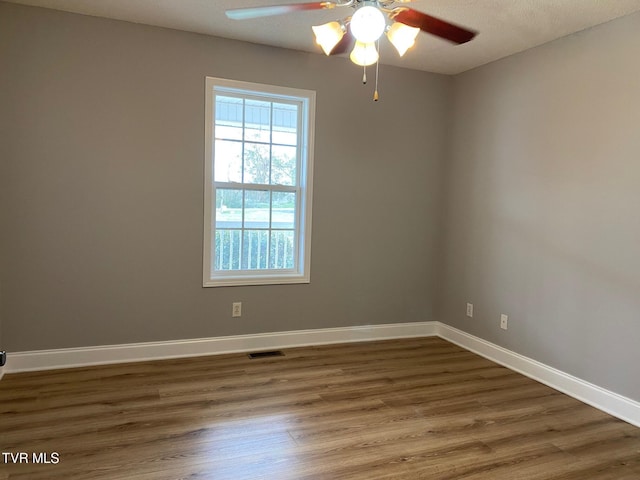 spare room with ceiling fan, dark hardwood / wood-style flooring, and a textured ceiling