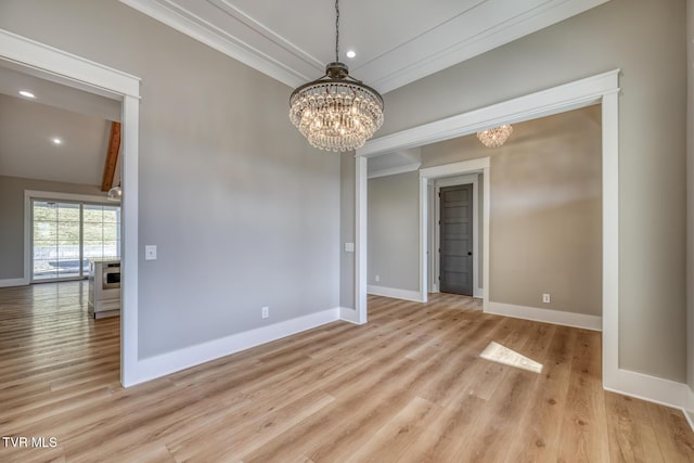 unfurnished room featuring light hardwood / wood-style floors, vaulted ceiling, and an inviting chandelier