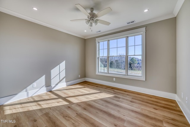 empty room with ceiling fan, ornamental molding, and light wood-type flooring