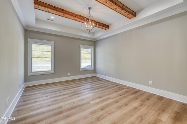 spare room with light wood-type flooring, plenty of natural light, and a notable chandelier