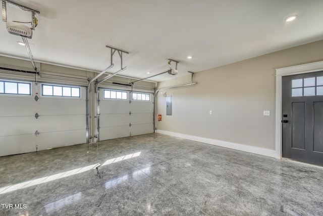 garage with a garage door opener and electric panel