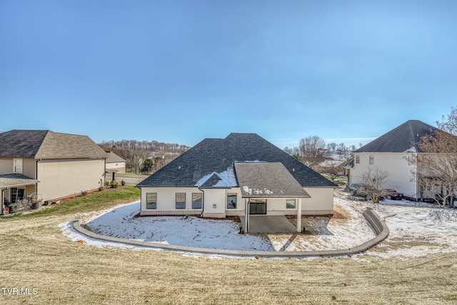 rear view of property with a lawn