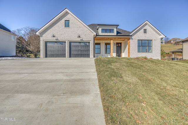 view of front of house with a front lawn and a garage