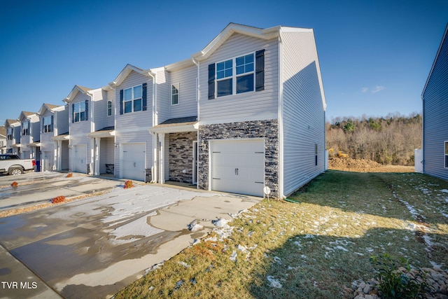 multi unit property with a front lawn and a garage