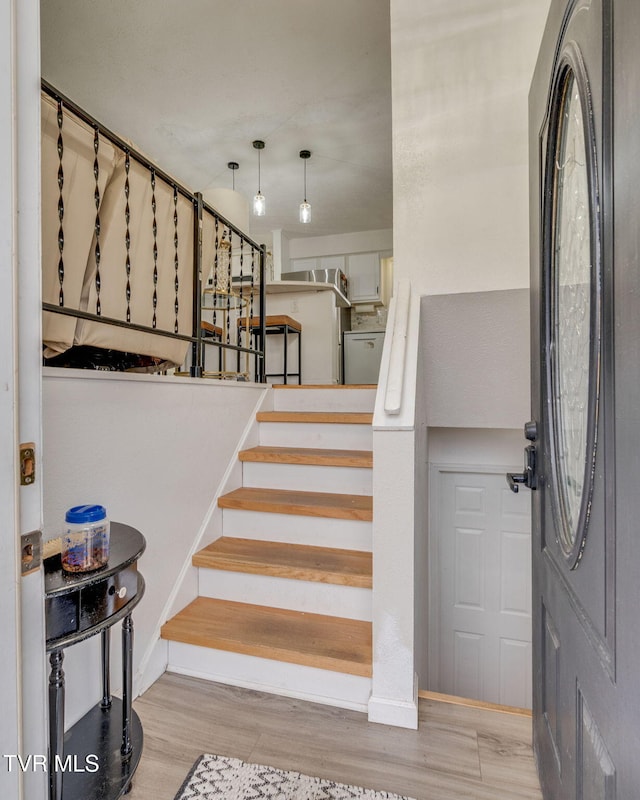 stairway with hardwood / wood-style floors