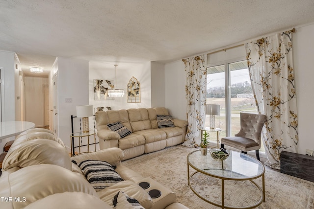 living room with a textured ceiling and an inviting chandelier