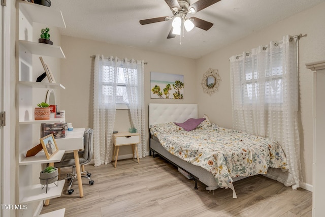 bedroom featuring light wood-type flooring and ceiling fan