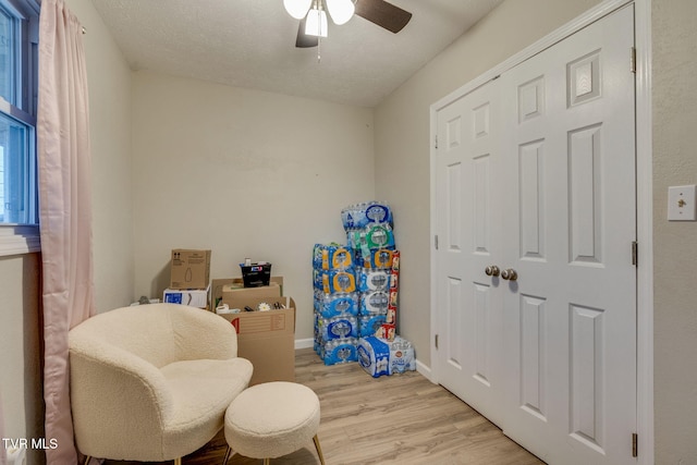 sitting room featuring ceiling fan and light hardwood / wood-style flooring