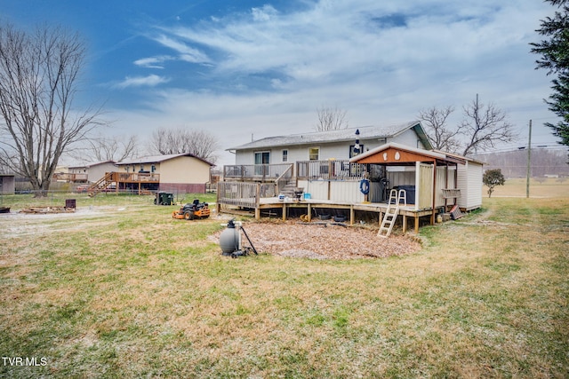 back of property with a yard and a wooden deck