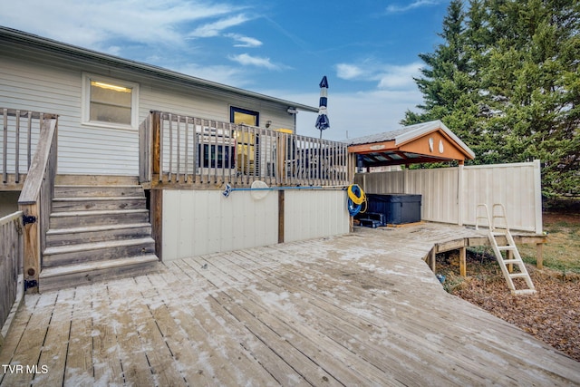 deck featuring a gazebo and a hot tub