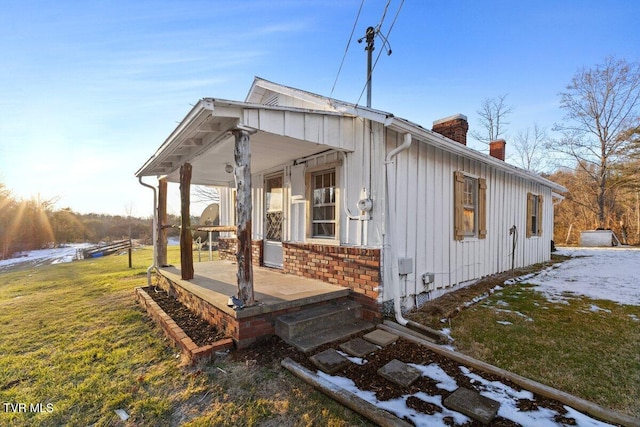 view of home's exterior featuring a porch and a yard