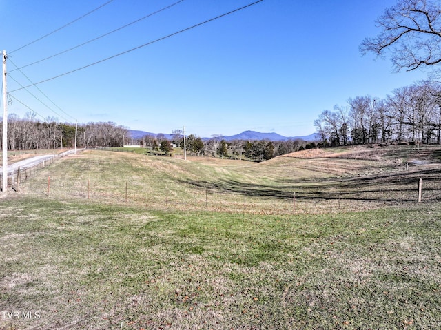 view of yard with a mountain view and a rural view