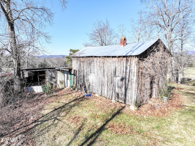 view of outbuilding with a yard