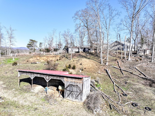 view of yard featuring a rural view and an outdoor structure